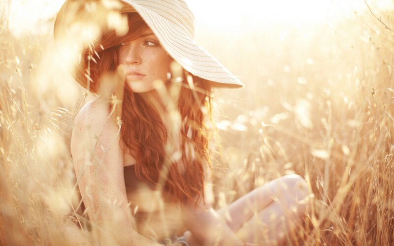 woman in field at sunset