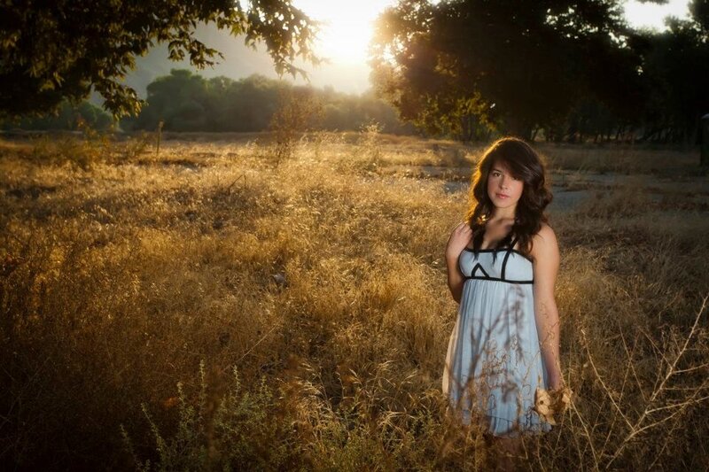 Woman in field at sunset