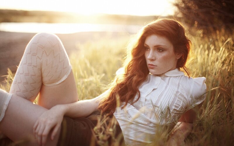 Woman in field at sunset