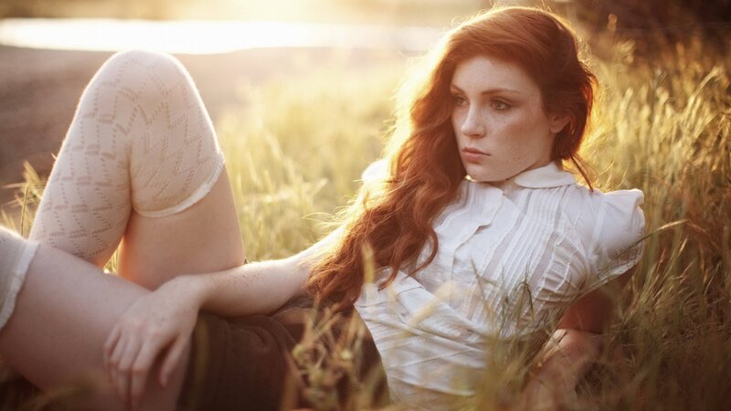 woman in field at sunset
