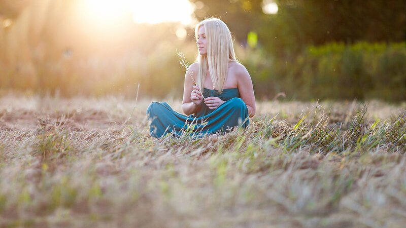 woman in field at sunset