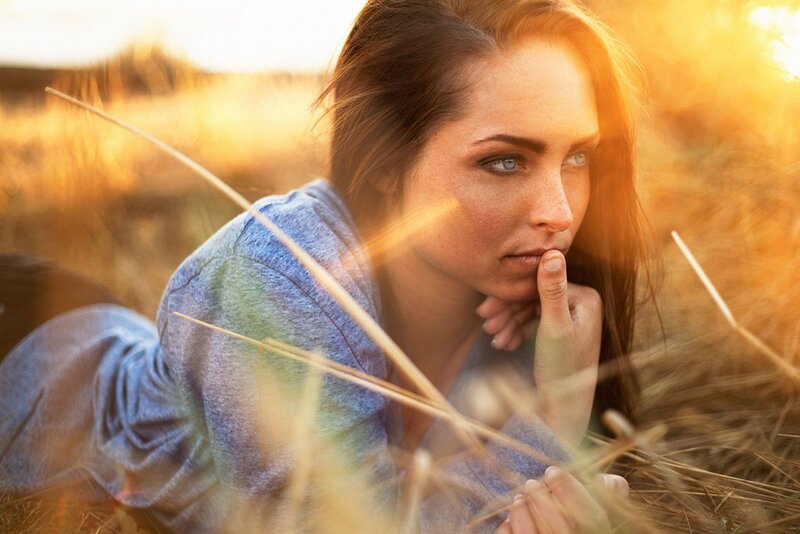 woman in field at sunset