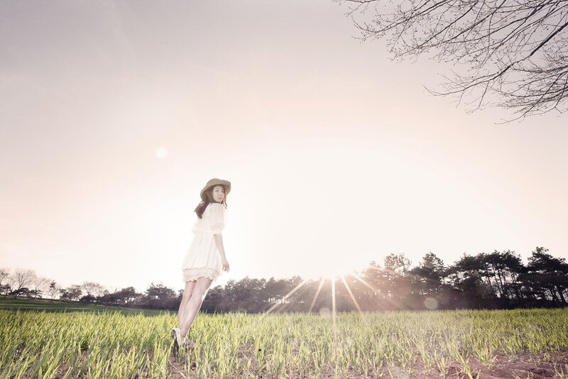 Woman in field at sunset