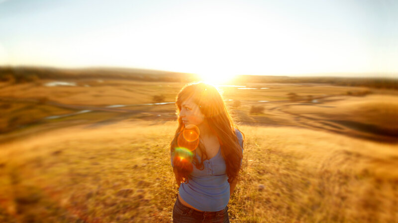 Woman in Field at Sunset — Gold