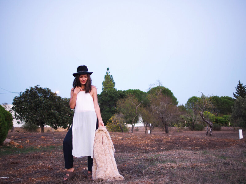 Woman in Field Holding Coat