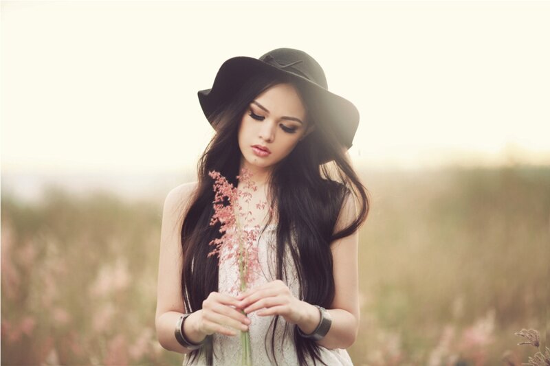 Woman in Field Holding Flower