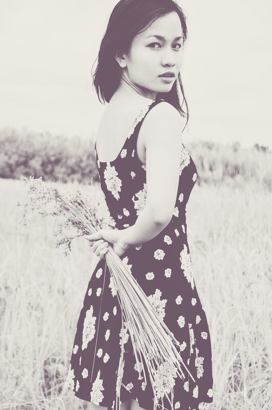 Woman in Field Holding Flowers