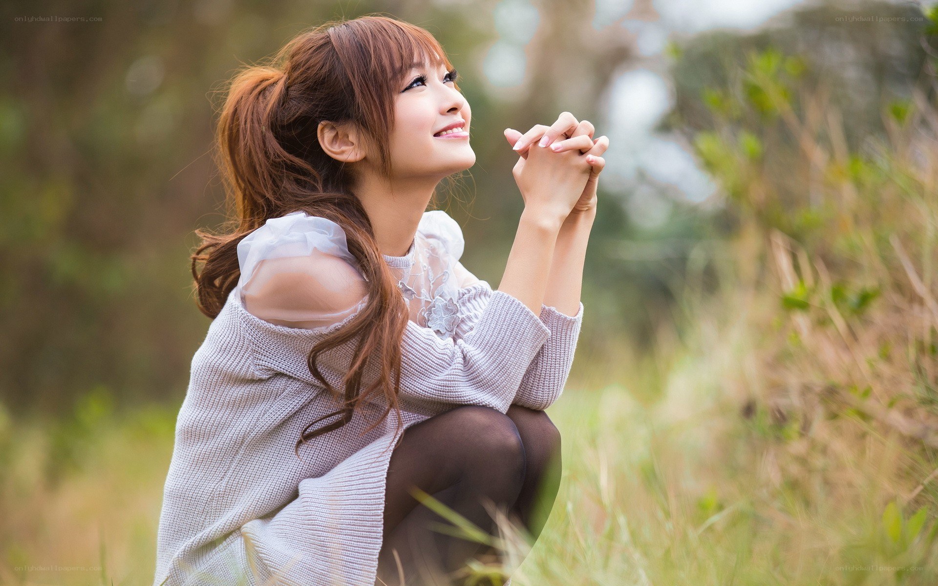 woman in field smiling