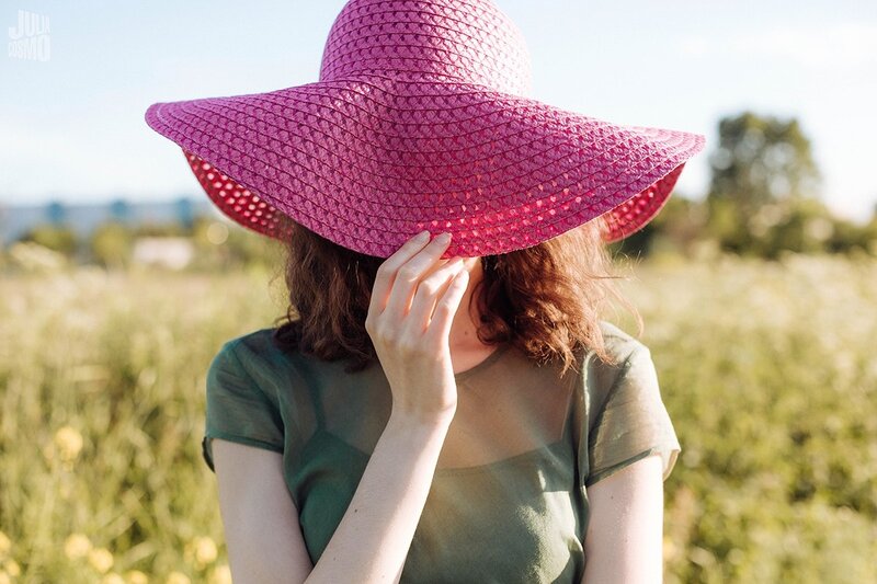 Woman in Field Wearing Hat