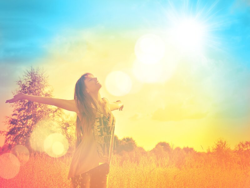Woman in Field with Arms Outstretched — Yellow, Serene