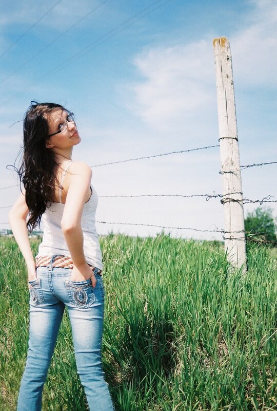 Woman in field with barbed wire