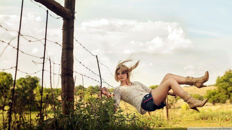 Woman in field with barbed wire