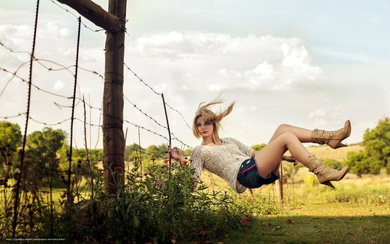Woman in field with barbed wire