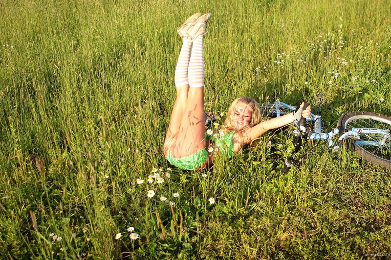 Woman in field with bicycle