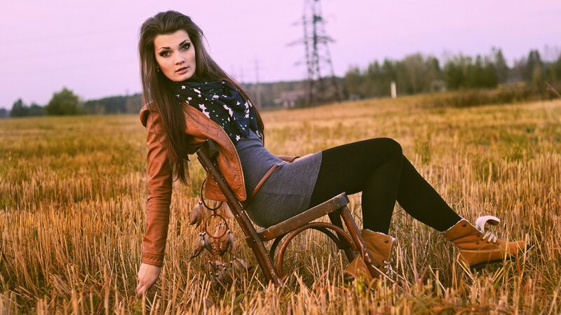 woman in field with chair