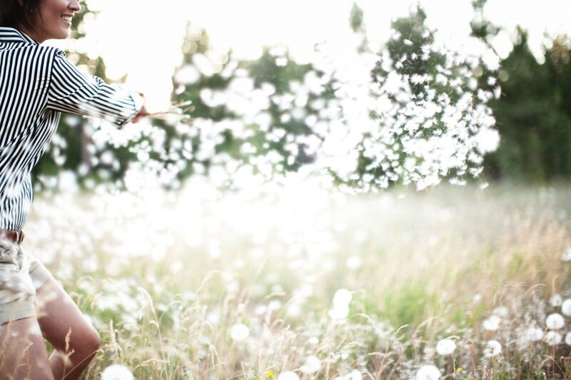 woman in field with dandelions