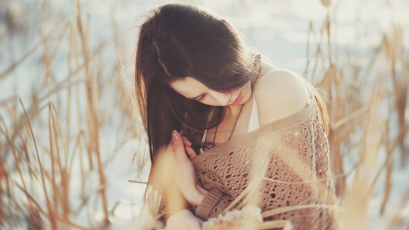 woman in field with dry grass