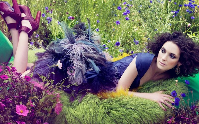 woman in field with feathers