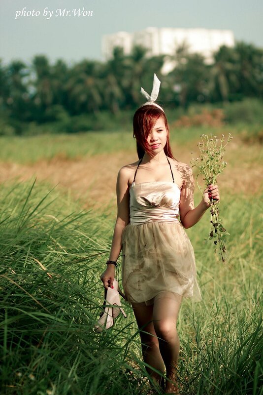 Woman in field with flowers