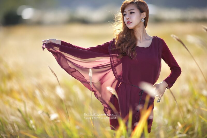 Woman in field with flowing scarf