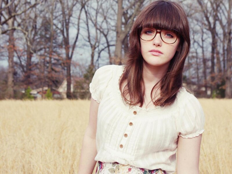 woman in field with glasses