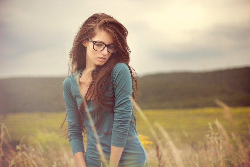 woman in field with glasses