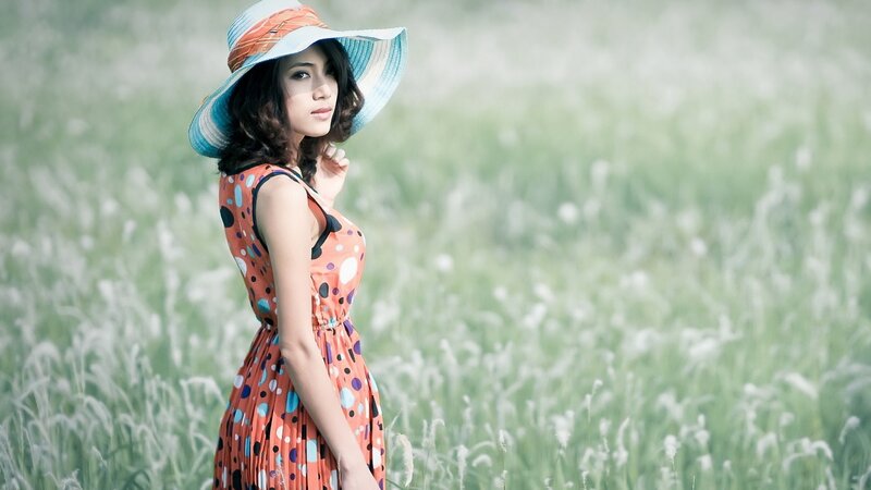 woman in field with hat