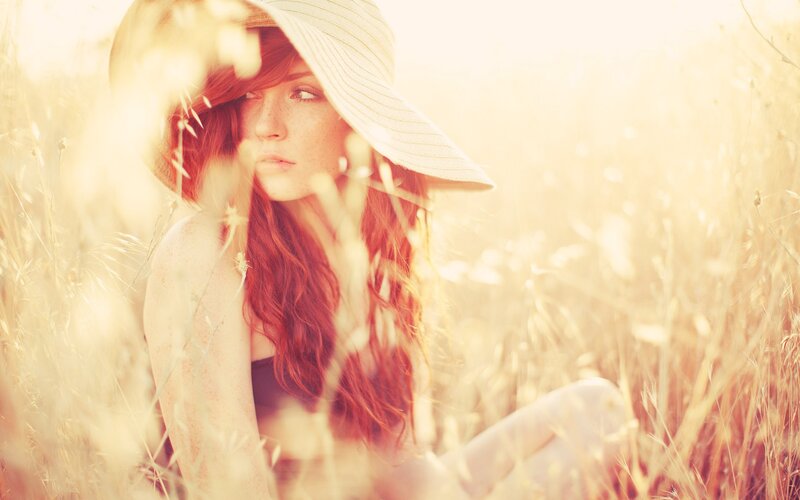 woman in field with hat