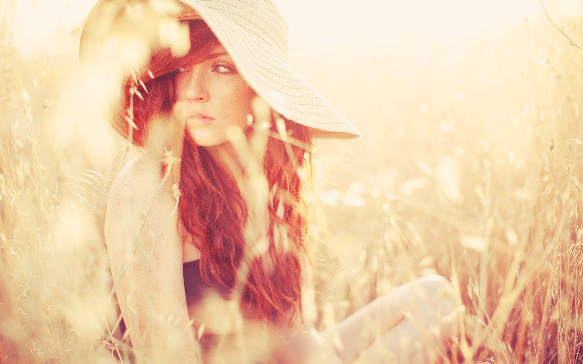 woman in field with hat