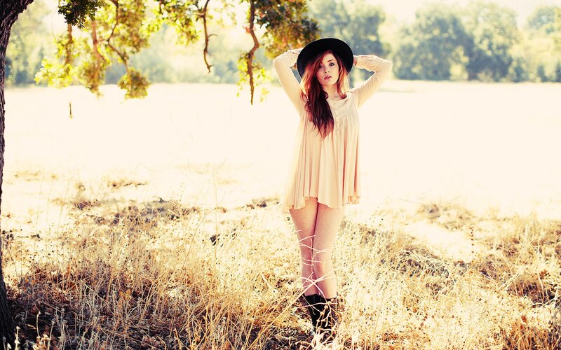 woman in field with hat