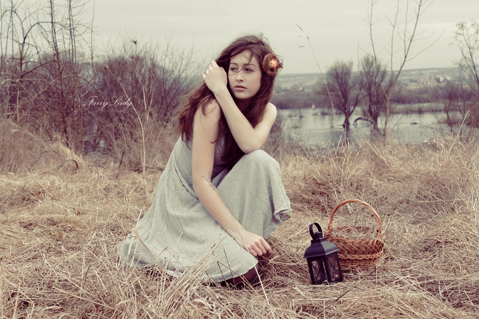 woman in field with lantern
