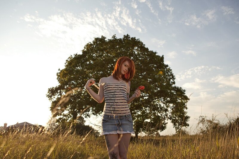 Woman in field with lollipop