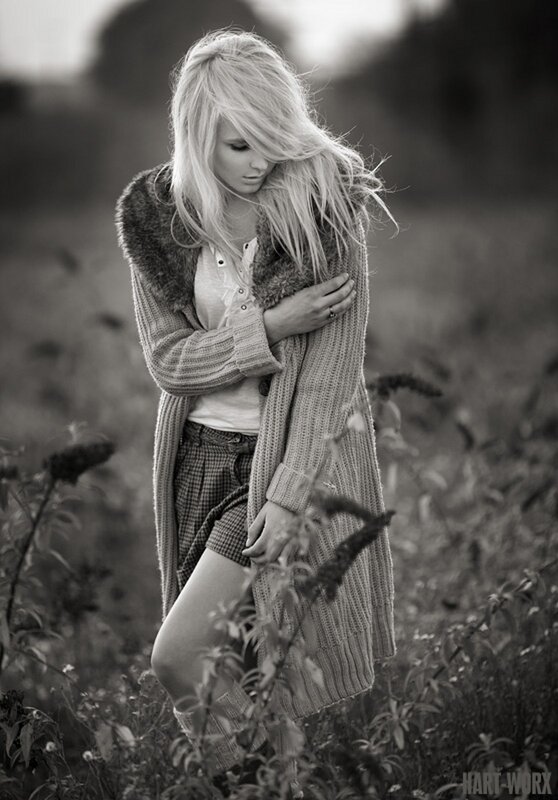woman in field with long coat