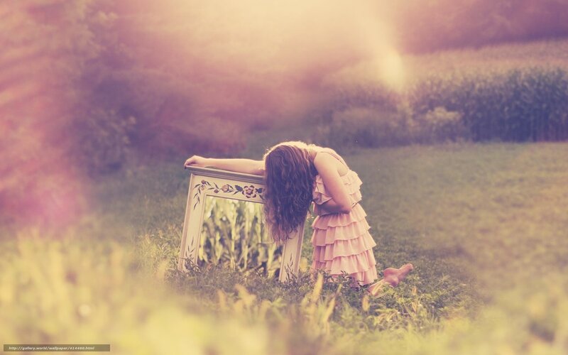 woman in field with mirror