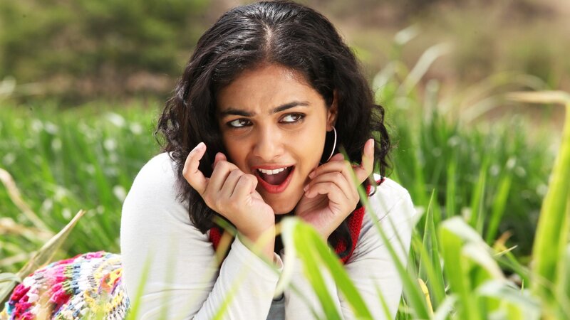 woman in field with playful expression