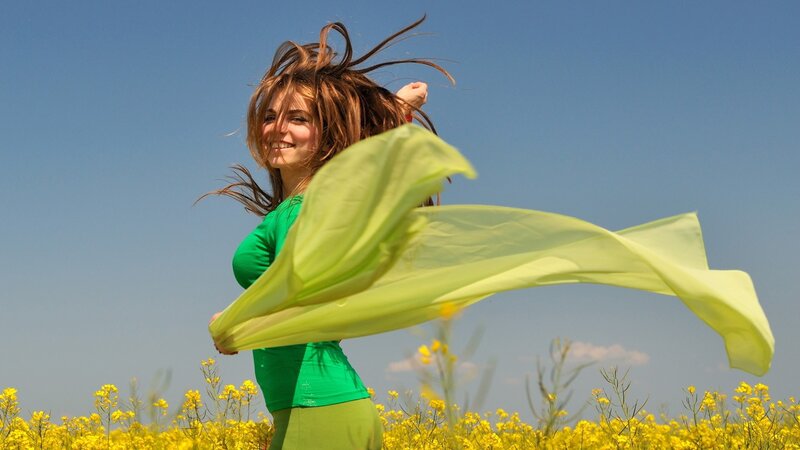 Woman in field with scarf