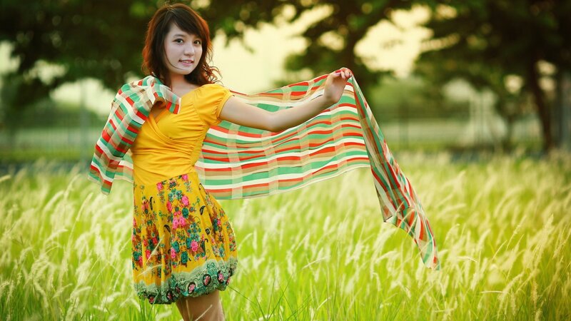 Woman in field with scarf