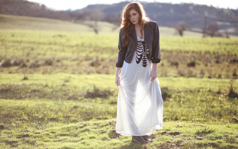 Woman in field with skeleton dress