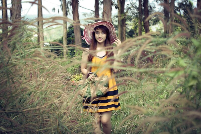 Woman in field with straw hat