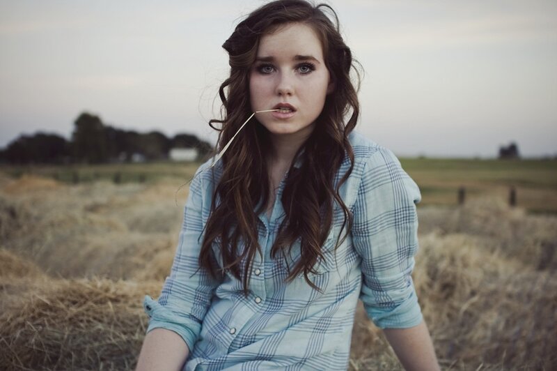 woman in field with straw