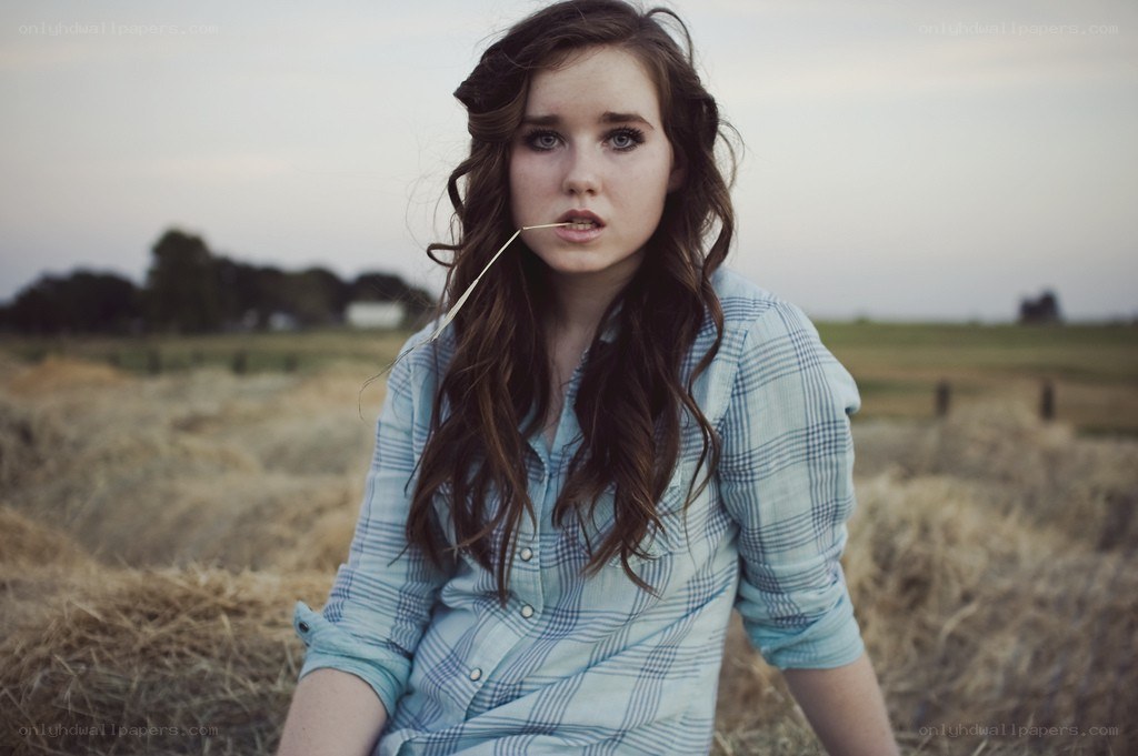 woman in field with straw