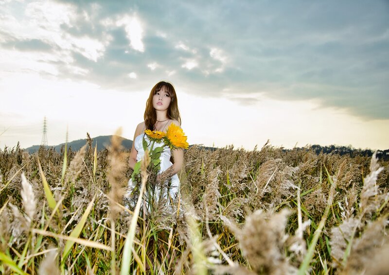 Woman in field with sunflowers