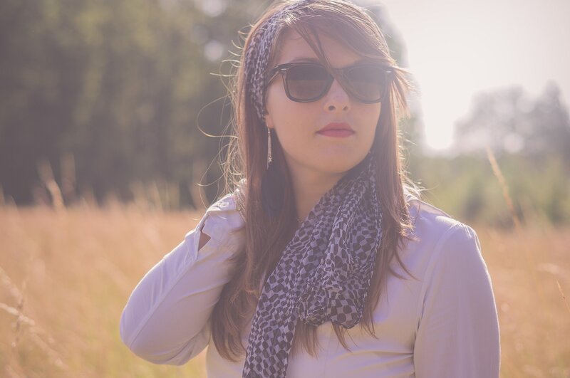 woman in field with sunglasses