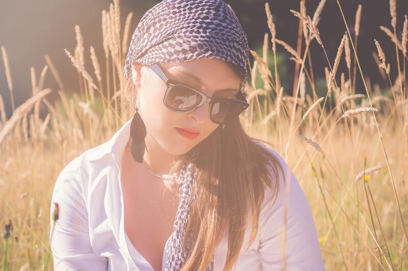 woman in field with sunglasses