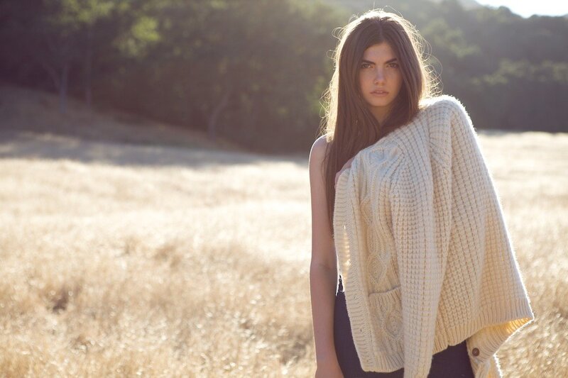 Woman in field with sweater