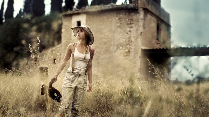 woman in field with teddy bear