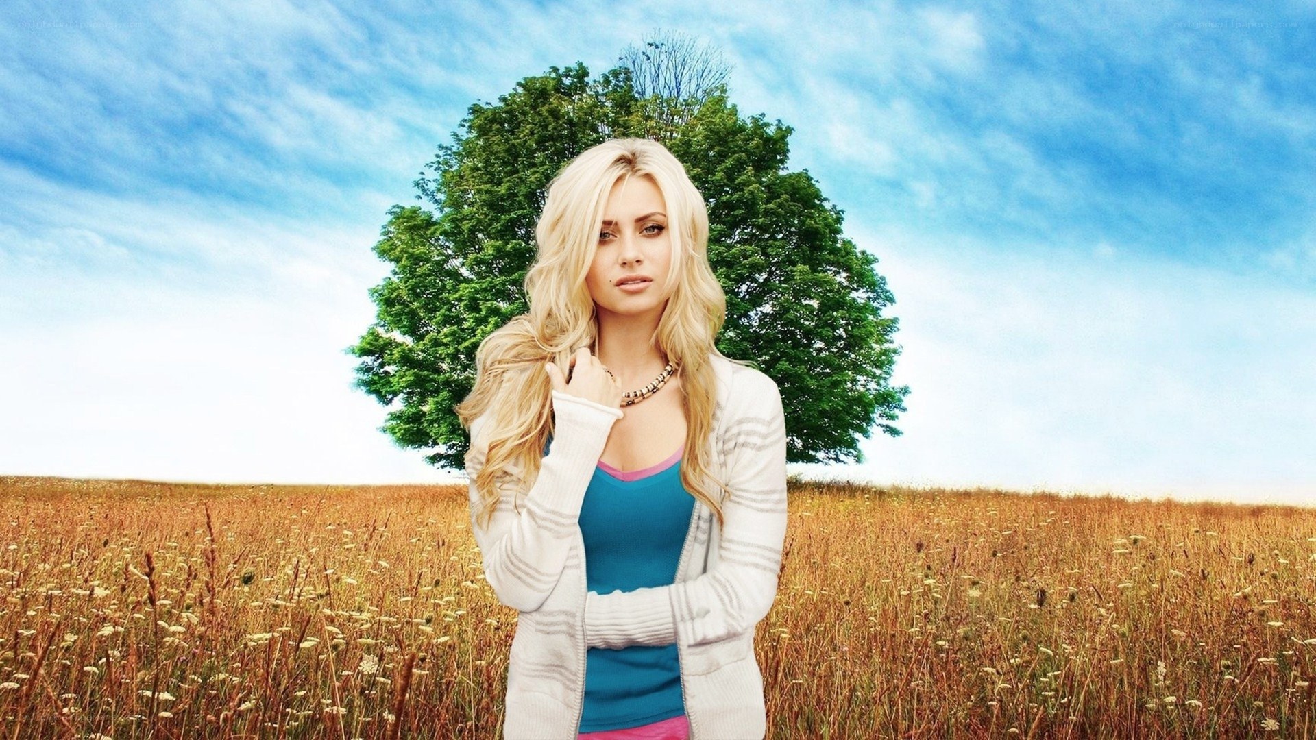 woman in field with tree