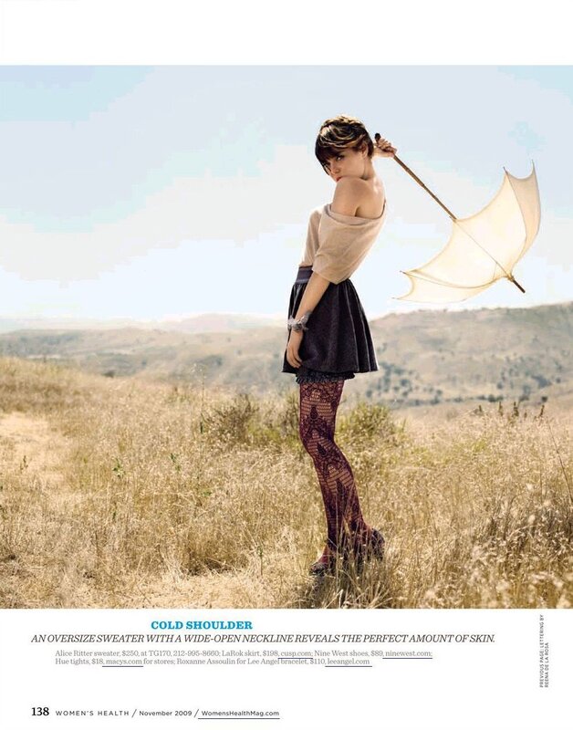 Woman in field with umbrella