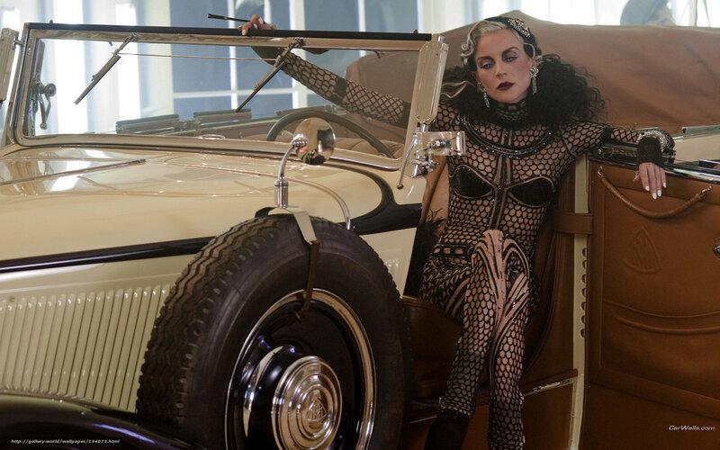woman in fishnet outfit with vintage car