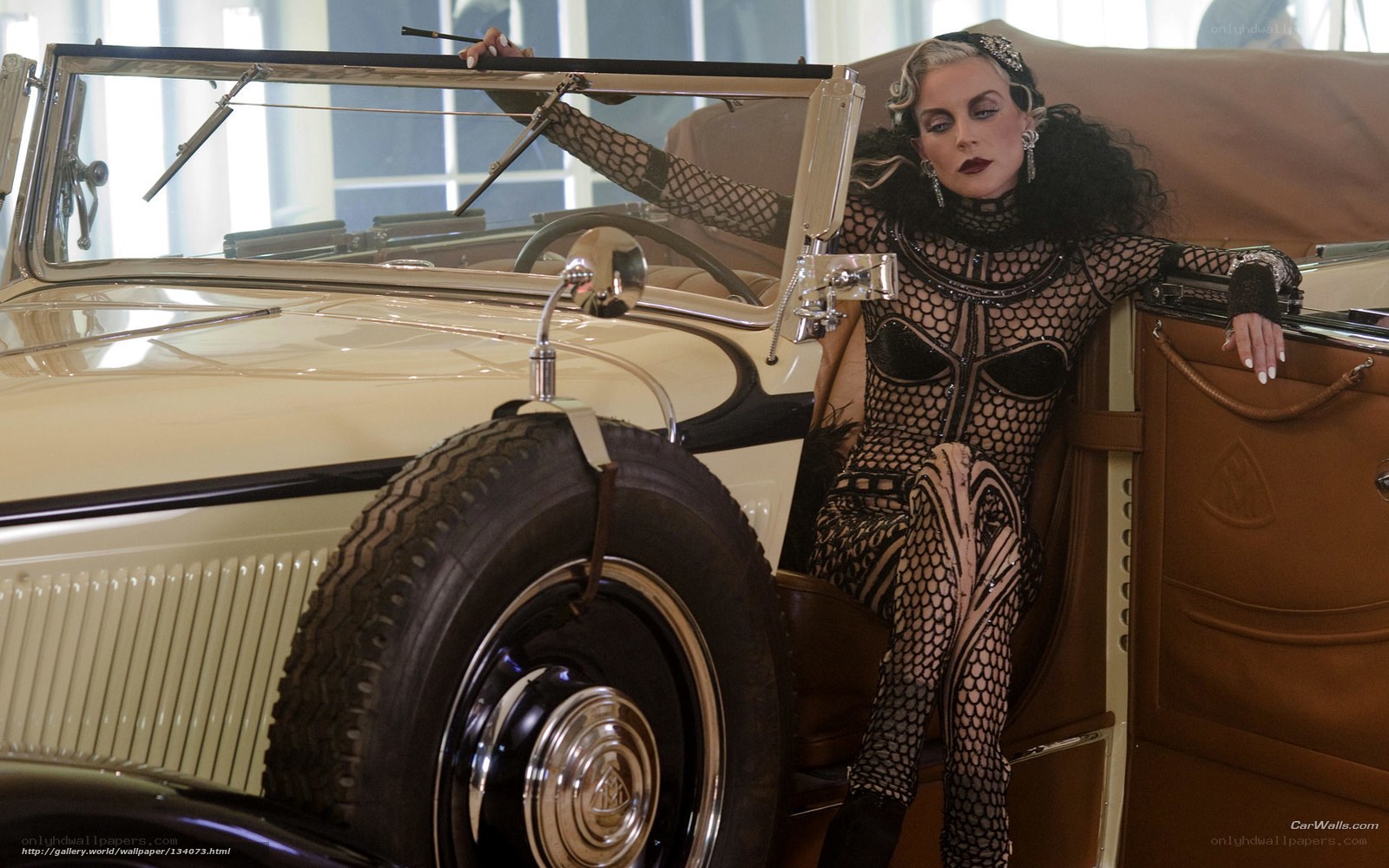 woman in fishnet outfit with vintage car